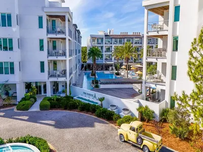 an old truck parked in front of a building at The Pointe on 30A #334 in Rosemary Beach