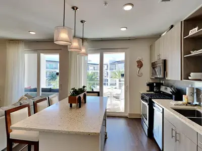 a kitchen with a kitchen island with a counter top at The Pointe on 30A #334 in Rosemary Beach