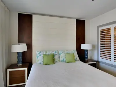a bedroom with a large white bed with two lamps at The Pointe on 30A #334 in Rosemary Beach