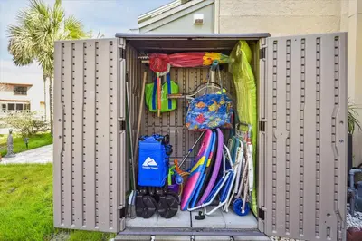 a container with umbrellas and other items in it at Gulf Highlands 219 by Book That Condo in Panama City Beach