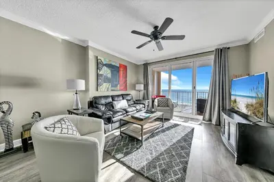 a living room with a couch and a flat screen tv at Ocean Reef 704 in Panama City Beach