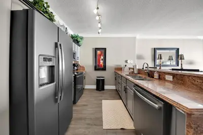 a kitchen with a stainless steel refrigerator and a counter at Ocean Reef 704 in Panama City Beach