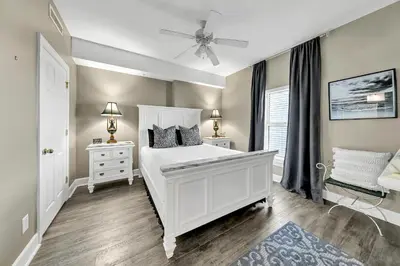 a bedroom with a white bed and two night stands at Ocean Reef 704 in Panama City Beach