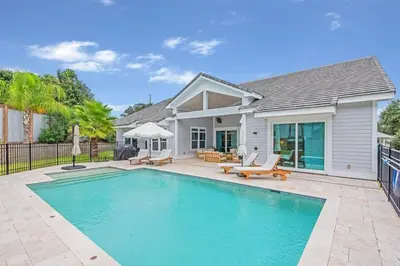 a swimming pool in front of a house at SOUTHERN SEABREEZE 5BR POOL & BEACH by Barclé in Rosemary Beach
