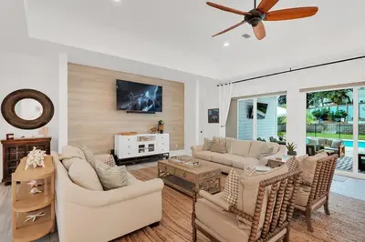 a living room with couches and a ceiling fan at SOUTHERN SEABREEZE 5BR POOL & BEACH by Barclé in Rosemary Beach