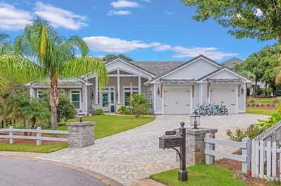 a house with a white fence and a driveway at SOUTHERN SEABREEZE 5BR POOL & BEACH by Barclé in Rosemary Beach