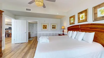 a bedroom with a large white bed with white pillows at Tidewater 0401 in Panama City Beach