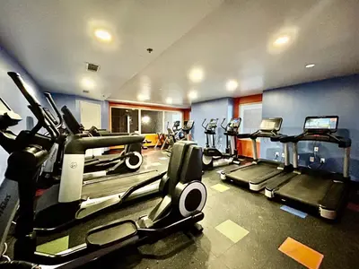 a gym with several treadmills and elliptical machines at Amazing views! Great beachfront Panama City Condo in Panama City Beach