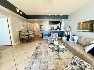 a living room with a couch and a table at Amazing views! Great beachfront Panama City Condo in Panama City Beach