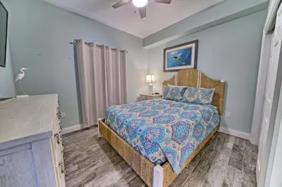 a bedroom with a bed with a bedspread on it at Oceanfront Paradise in Gated Community - 2304 condo in Panama City Beach