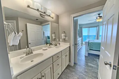 a bathroom with two sinks and a large mirror at Oceanfront Paradise in Gated Community - 2304 condo in Panama City Beach