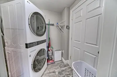 a white laundry room with a washer and dryer at Oceanfront Paradise in Gated Community - 2304 condo in Panama City Beach