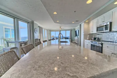 a large kitchen with a large marble counter top at Oceanfront Retreat with Panoramic Views - 0301 condo in Panama City Beach