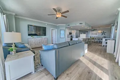 a living room with a couch and a ceiling fan at Oceanfront Retreat with Panoramic Views - 0301 condo in Panama City Beach