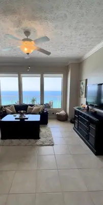 a living room with a couch and a flat screen tv at Seaside Bliss in Gated Community - 1504 condo in Panama City Beach