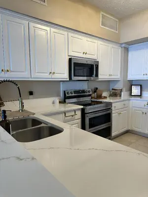 a kitchen with white cabinets and a sink at Seaside Bliss in Gated Community - 1504 condo in Panama City Beach