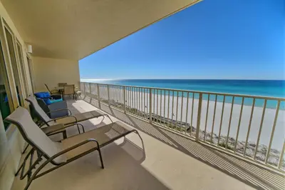 a balcony with chairs and a view of the ocean at Oceanfront Paradise with Pool Access - 0606 condo in Panama City Beach