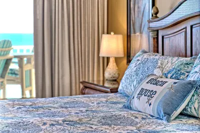 a bedroom with a bed with a pillow on it at Oceanfront Paradise with Pool Access - 0606 condo in Panama City Beach