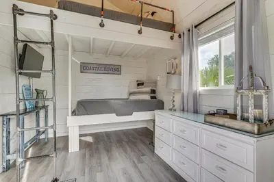 a bedroom in a tiny house with a bed and a desk at Panama City Beach Home with Private Pool and Gas Grill in Panama City Beach