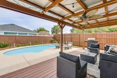 a patio with a pergola and a swimming pool at Panama City Beach Home with Private Pool and Gas Grill in Panama City Beach