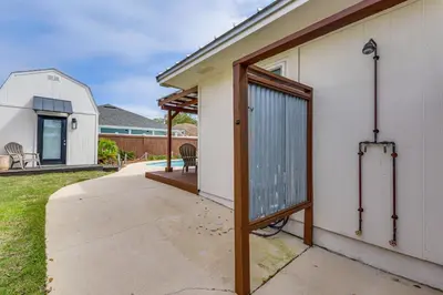 a door to a house with a patio at Panama City Beach Home with Private Pool and Gas Grill in Panama City Beach