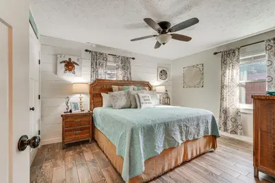 a bedroom with a bed and a ceiling fan at Panama City Beach Home with Private Pool and Gas Grill in Panama City Beach