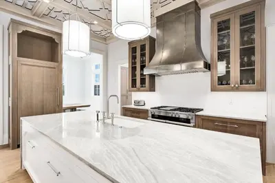 a white kitchen with a large white counter top at Seaclusion at Seagrove in Santa Rosa Beach