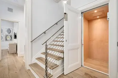 a staircase in a home with white walls and wood floors at Seaclusion at Seagrove in Santa Rosa Beach