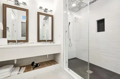 a white bathroom with a shower and a sink at Emerald Palms in Inlet Beach