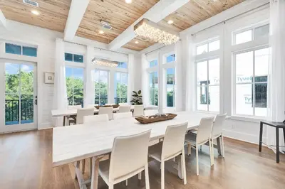 a dining room with a large wooden table and chairs at Emerald Palms in Inlet Beach