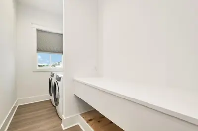 a laundry room with a washer and dryer at Emerald Palms in Inlet Beach