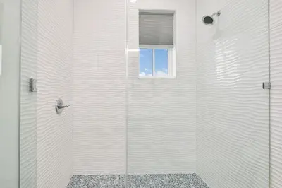 a white shower with a window in a bathroom at Emerald Palms in Inlet Beach
