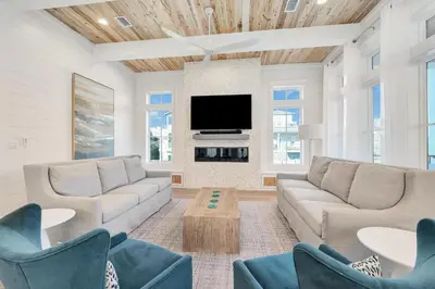 a living room with couches and a flat screen tv at Emerald Palms in Inlet Beach