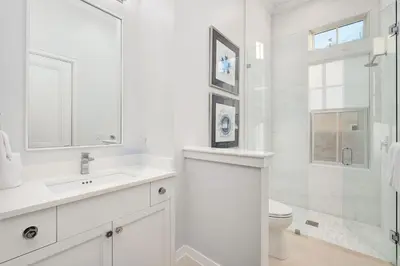 a white bathroom with a sink and a toilet at Sanctuary at Seagrove in Santa Rosa Beach