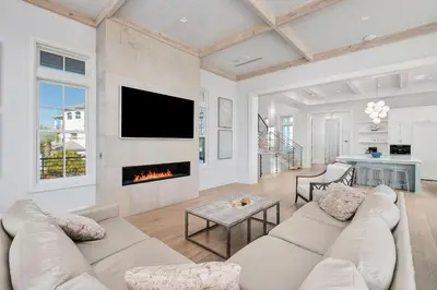 a living room with a couch and a fireplace at Sanctuary at Seagrove in Santa Rosa Beach
