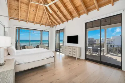 a bedroom with a bed and a view of the ocean at Sanctuary at Seagrove in Santa Rosa Beach
