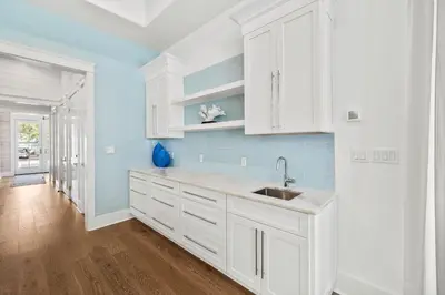 a kitchen with white cabinets and a sink at Casa al Mare in Santa Rosa Beach