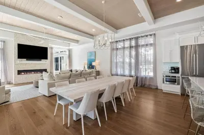 a dining room with a large wooden table and chairs at Casa al Mare in Santa Rosa Beach