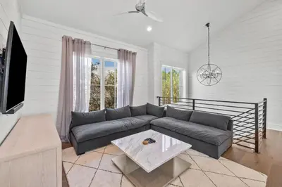 a living room with a couch and a tv at Casa al Mare in Santa Rosa Beach