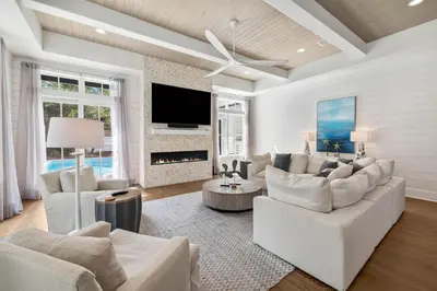 a living room with white furniture and a fireplace at Casa al Mare in Santa Rosa Beach