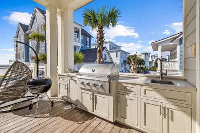 a kitchen with a stove and a grill on a deck at Seagrove Sparrow in Santa Rosa Beach