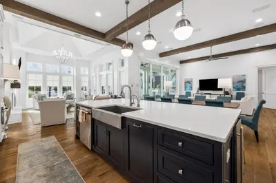 a kitchen with a sink and a living room at Seagrove Sparrow in Santa Rosa Beach