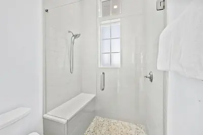 a white bathroom with a shower and a toilet at Seagrove Sparrow in Santa Rosa Beach