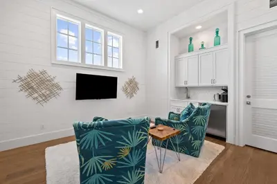 a living room with two chairs and a table at Seagrove Sparrow in Santa Rosa Beach