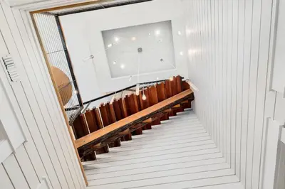 a staircase leading up to a building with a window at St. Ivory in Rosemary Beach