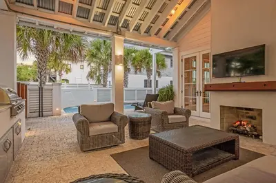 a living room with chairs and a fireplace at St. Ivory in Rosemary Beach