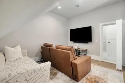 a living room with a couch and a flat screen tv at Coastal Dream in Santa Rosa Beach
