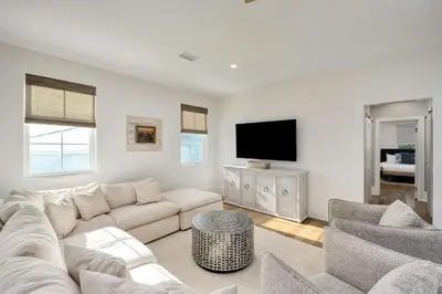 a living room with a couch and a flat screen tv at Coastal Dream in Santa Rosa Beach