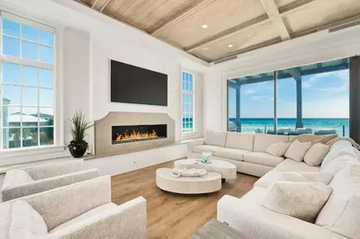a living room with a couch and a fireplace at Gulf Front Sanctuary in Santa Rosa Beach