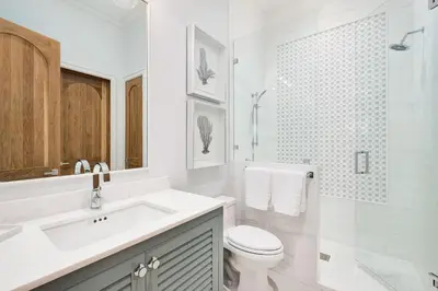 a white bathroom with a sink and a toilet at Gulf Front Sanctuary in Santa Rosa Beach